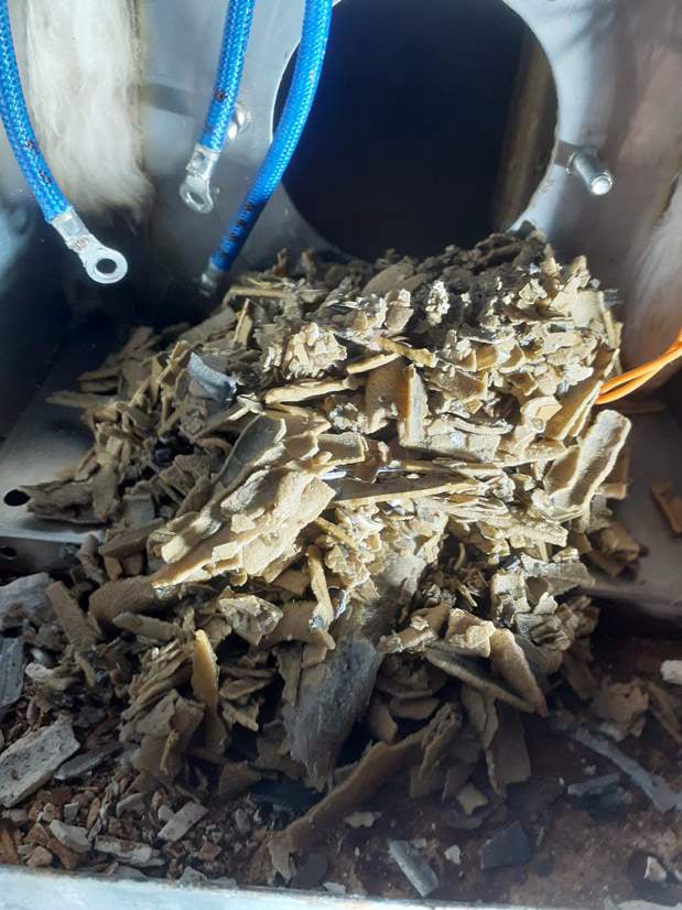 Close-up of sauna heater cleaning process, maintaining pristine condition